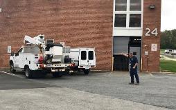 Goddard Space Flight Center employee Lou Simmons guides a bucket truck backing up to avoid any potential hazards created by the limited visibility of the lifting apparatus.
