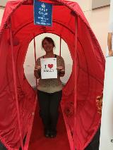 Langley Research Center Employee Angela Bynum shows her love of safety inside the colon at the colon health booth.