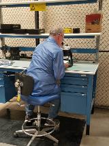 Quality Assurance Inspector LeRoy Marsh inspects a card as part of his Quality Assurance duties in the shipping and receiving area of Armstrong Flight Research Center. He uses an Electrostatic discharge chair, mat and strap.