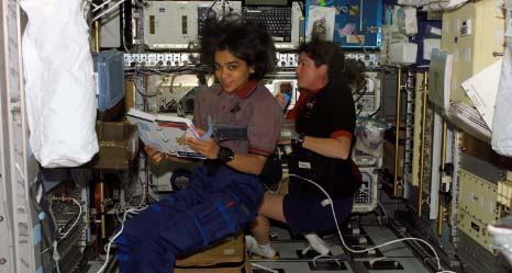 Kalpana Chawla and Laurel Clark work in SPACEHAB